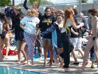 Swimming team dancing next to the pool